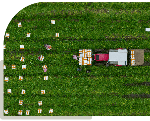 Aerial view of farm workers and tractor